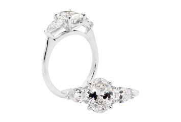 Oval trilogy ring featuring oval brilliant cut and pear cut diamond. Available in White Gold, Yellow Gold, Rose Gold or Platinum