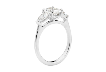 Oval trilogy ring featuring oval brilliant cut and pear cut diamond. Available in White Gold, Yellow Gold, Rose Gold or Platinum