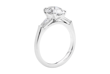 Oval Trilogy ring with oval brilliant cut and tapered baguette. Available in White Gold, Yellow Gold, Rose Gold or Platinum