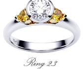 Half Bezel Round Brilliant Cut featuring Two Yellow Diamonds In The Shoulders